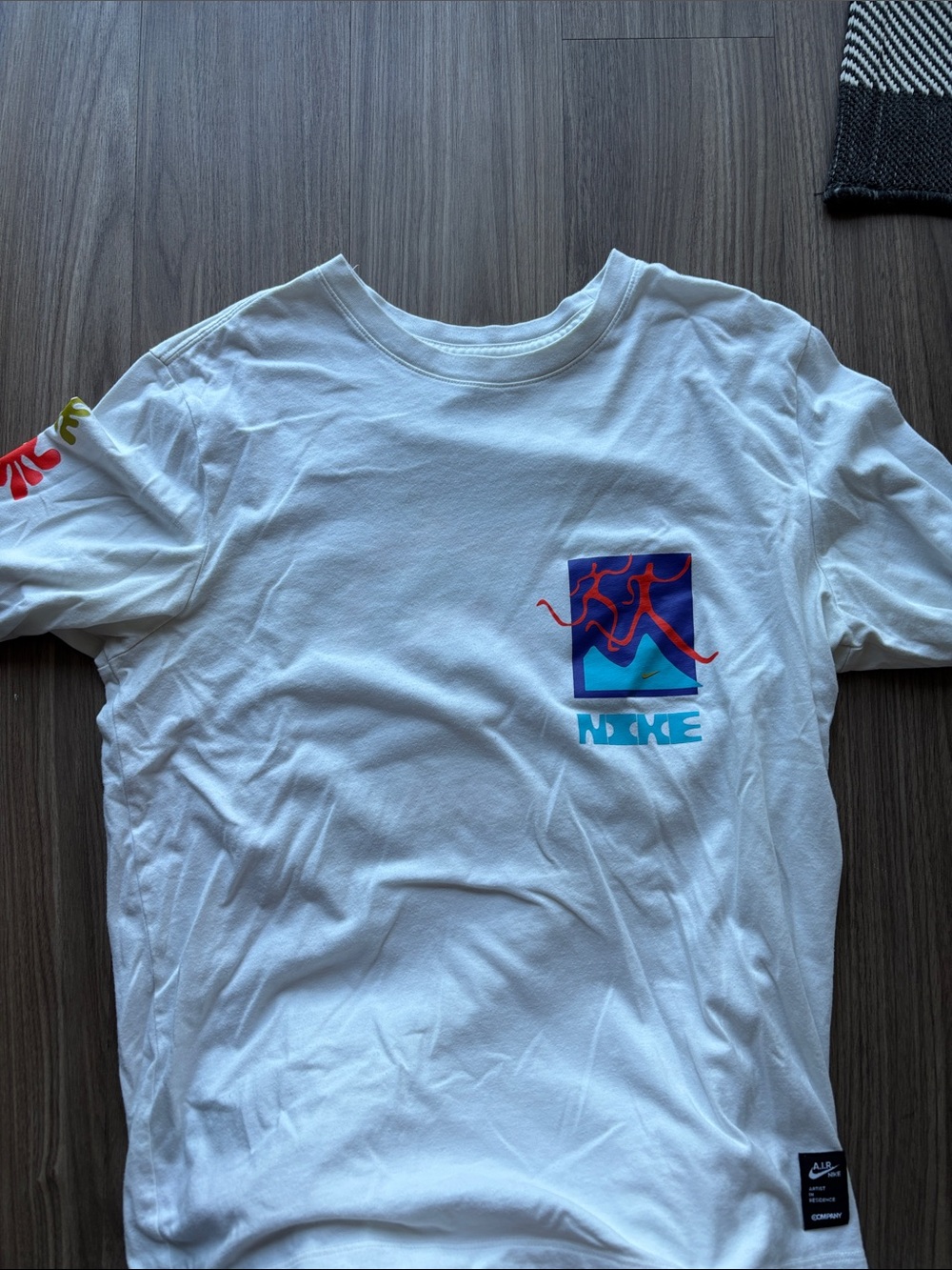 Nike White Tee with Blue, Teal and Red Abstract Pocket Graphic